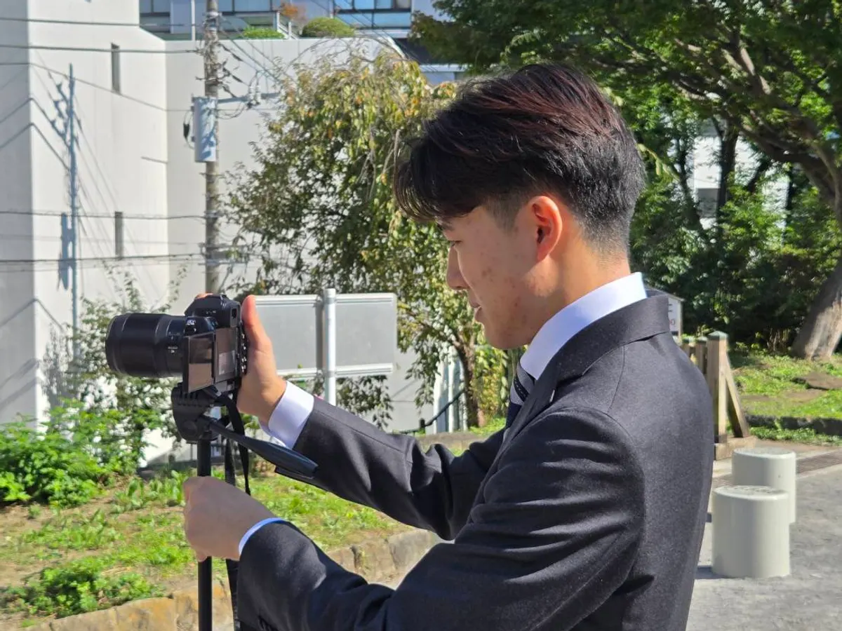 A member taking photos with a camera on a tripod